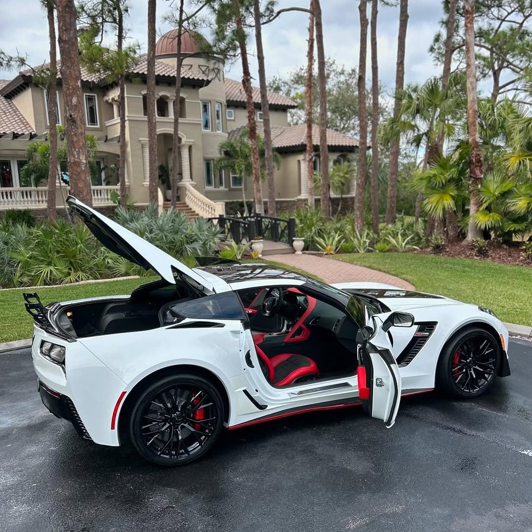 White Corvette Z06 with doors open, red interior, detailed at a Tampa Bay estate